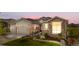 Charming home featuring a manicured lawn, stone accents, and a convenient three-car garage at 8691 S Sicily Ct, Aurora, CO 80016