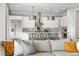Modern kitchen with stainless steel appliances, white cabinets, pendant lighting, and seating at the center island at 8691 S Sicily Ct, Aurora, CO 80016