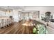 Bright open-concept living area featuring elegant hardwood floors and seamless flow to the kitchen at 8691 S Sicily Ct, Aurora, CO 80016