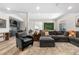 Spacious finished basement living room with stylish decor, a modern kitchen area, and recessed lighting at 8691 S Sicily Ct, Aurora, CO 80016