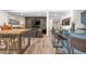 Basement living space featuring a bar, fireplace, TV, comfortable seating, and modern flooring at 8691 S Sicily Ct, Aurora, CO 80016