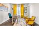 Inviting home office with yellow accents, a comfortable chair, and ample natural light creating a vibrant workspace at 8691 S Sicily Ct, Aurora, CO 80016