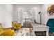 Bright home office with a desk, vintage chairs, and decor creating a comfortable workspace at 8691 S Sicily Ct, Aurora, CO 80016