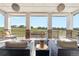 Inviting covered patio with stone pillars, outdoor seating, and panoramic views of the neighborhood at 8691 S Sicily Ct, Aurora, CO 80016