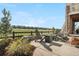 Outdoor patio area with fire pit and seating, overlooking a green space and beautiful neighborhood homes at 8691 S Sicily Ct, Aurora, CO 80016