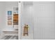 Bright bathroom with a sleek, tiled walk-in shower and convenient built-in shelving at 8691 S Sicily Ct, Aurora, CO 80016