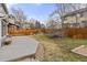 Large wooden deck overlooking an open lawn with stone edging and mature landscaping at 11076 W Dumbarton Cir, Littleton, CO 80127