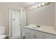 Bright bathroom featuring a shower, a large vanity, and sleek chrome hardware at 11076 W Dumbarton Cir, Littleton, CO 80127