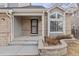 Charming front entrance with brick accents and a well-maintained walkway, providing curb appeal at 11076 W Dumbarton Cir, Littleton, CO 80127