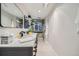 Bathroom with dual sinks, modern vanity, and tiled walk-in shower with window at 1350 Lawrence St # 2F, Denver, CO 80204