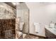 Bathroom features marble tile shower with glass door and marble tile floors at 1350 Lawrence St # 2F, Denver, CO 80204
