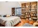Bright bedroom features built-in wood bookshelves, hardwood floors and a large window at 1350 Lawrence St # 2F, Denver, CO 80204