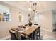 Modern dining room with stylish lighting and seating for six at 1350 Lawrence St # 2F, Denver, CO 80204