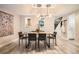 Elegant dining room with modern light fixtures and a view into the kitchen at 1350 Lawrence St # 2F, Denver, CO 80204