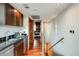 Hallway featuring hardwood floors, modern lighting, and convenient wet bar area leading to the bedroom at 1350 Lawrence St # 2F, Denver, CO 80204