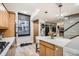 Bright kitchen featuring an island, modern appliances, and a large window with a view at 1350 Lawrence St # 2F, Denver, CO 80204