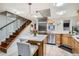 Well-lit kitchen with stainless steel appliances, a central island, and access to stairs at 1350 Lawrence St # 2F, Denver, CO 80204