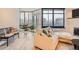 Living room featuring a plush sectional sofa, bright windows, and sleek flooring at 1350 Lawrence St # 2F, Denver, CO 80204