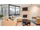 Cozy living room with large windows, a fireplace, and ample seating at 1350 Lawrence St # 2F, Denver, CO 80204