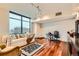 Living room with hardwood floors, large window, and comfortable seating at 1350 Lawrence St # 2F, Denver, CO 80204