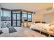 Spacious main bedroom with large windows, city views, and a cozy fireplace at 1350 Lawrence St # 2F, Denver, CO 80204