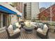 Outdoor rooftop patio with stylish seating and an inviting fire pit at 1350 Lawrence St # 2F, Denver, CO 80204