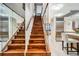 Elegant wooden staircase with glass railing next to the kitchen area at 1350 Lawrence St # 2F, Denver, CO 80204