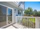 Charming back deck with sliding glass doors, white railings, and a view of the well-maintained backyard at 9200 W Indore Dr, Littleton, CO 80128