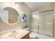 Bathroom featuring a glass-enclosed shower and single sink vanity at 9200 W Indore Dr, Littleton, CO 80128