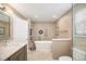 Bright bathroom featuring a soaking tub and granite counters at 9200 W Indore Dr, Littleton, CO 80128
