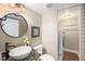 Stylish bathroom with a vessel sink, granite countertop, modern faucet, and a washer and dryer unit at 9200 W Indore Dr, Littleton, CO 80128