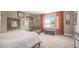 Bright bedroom featuring a large window, sitting area, and neutral decor at 9200 W Indore Dr, Littleton, CO 80128