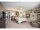 Spacious bedroom featuring a ceiling fan and warm, neutral carpeting at 9200 W Indore Dr, Littleton, CO 80128