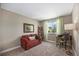 Cozy bedroom with a red sofa, ladder shelving, and window at 9200 W Indore Dr, Littleton, CO 80128