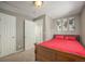 Cozy bedroom with a wooden sleigh bed covered in a red comforter and three world map prints hanging on the wall at 9200 W Indore Dr, Littleton, CO 80128