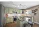 Well-lit kitchen features granite countertops, stainless steel appliances and an island with seating at 9200 W Indore Dr, Littleton, CO 80128