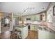 Well-lit kitchen features granite countertops, stainless steel appliances and an island with seating at 9200 W Indore Dr, Littleton, CO 80128