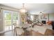 Open concept living and dining area with a fireplace and sliding glass door to the balcony at 9200 W Indore Dr, Littleton, CO 80128
