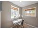 Bright office space featuring two windows, a desk with a lamp, and a comfortable chair, perfect for work or study at 9200 W Indore Dr, Littleton, CO 80128