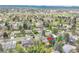 Aerial view of the property showing the surrounding neighborhood with mature trees at 7058 S Madison Way, Centennial, CO 80122