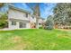 Beautifully landscaped backyard with large lawn and mature trees at 7058 S Madison Way, Centennial, CO 80122