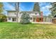 Lush green backyard with mature trees surrounding the property at 7058 S Madison Way, Centennial, CO 80122