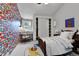 Bright bedroom with colorful flag wallpaper and a built-in desk near the window at 7058 S Madison Way, Centennial, CO 80122