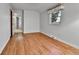 Second bright bedroom with hardwood floors and a view of trees outside the window at 7058 S Madison Way, Centennial, CO 80122