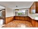 Dining room with brick flooring, wood cabinets, and a window at 7058 S Madison Way, Centennial, CO 80122