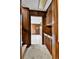 Inviting entryway features wood paneling, carpet flooring, and built-in storage cabinets at 7058 S Madison Way, Centennial, CO 80122