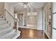 Elegant foyer with tile flooring, chandelier, staircase, and views to multiple rooms at 7058 S Madison Way, Centennial, CO 80122