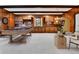 Large game room with pool table, arcade game, and built-in bar area at 7058 S Madison Way, Centennial, CO 80122