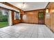Cozy sun room features wood paneling, tile flooring, and abundant natural light at 7058 S Madison Way, Centennial, CO 80122