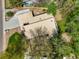Aerial perspective of the property showcasing its unique architecture and lush surroundings with mature trees at 5450 Mohawk Rd, Littleton, CO 80123